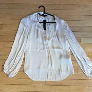 Ivory/cream colored silky top. Very chic; new with tags